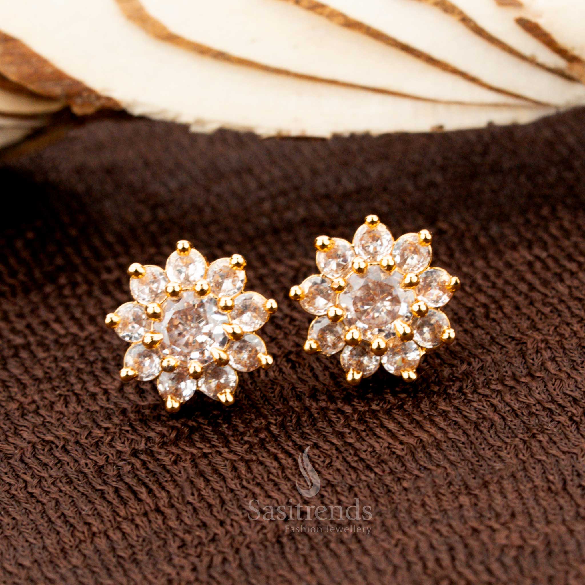 Timeless gold-plated flower stud earrings adorned with a sparkling white American diamond centre stone, a graceful accessory for weddings, ethnic outfits, and festive occasions - Sasitrends