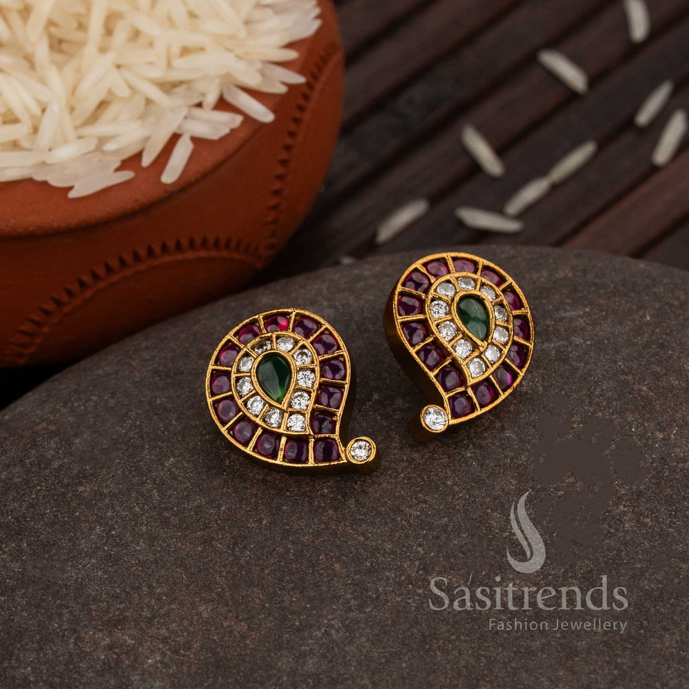 Graceful Matte Gold Plated Paisley Stud Earrings With Ruby-Green American Diamond Stone Accents, A Perfect Traditional Festive Jewellery Design For Saree Styling And Cultural Occasions – Sasitrends