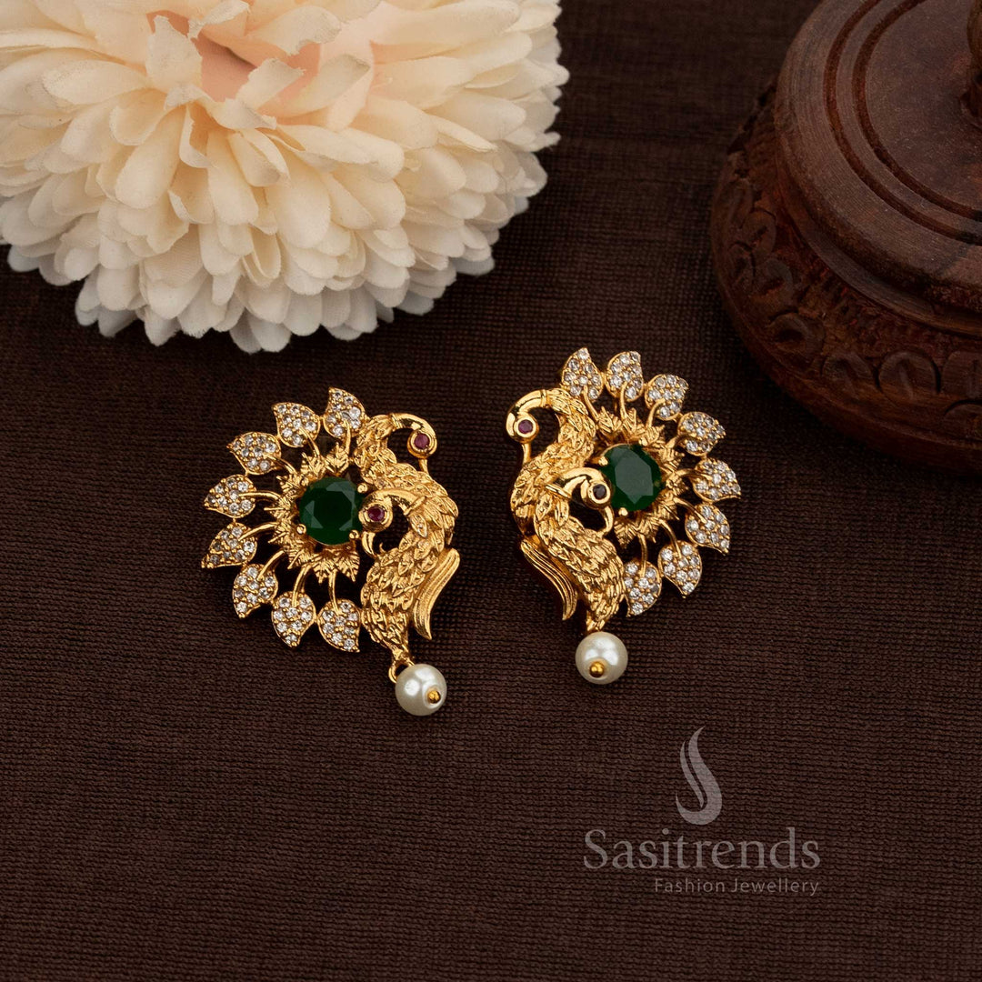 Matte Gold Plated Temple Peacock Stud Earrings Adorned With Sparkling American Diamond Stones And A Graceful Pearl Drop, Perfect For Bridal Ensembles And Festive Occasions – Sasitrends