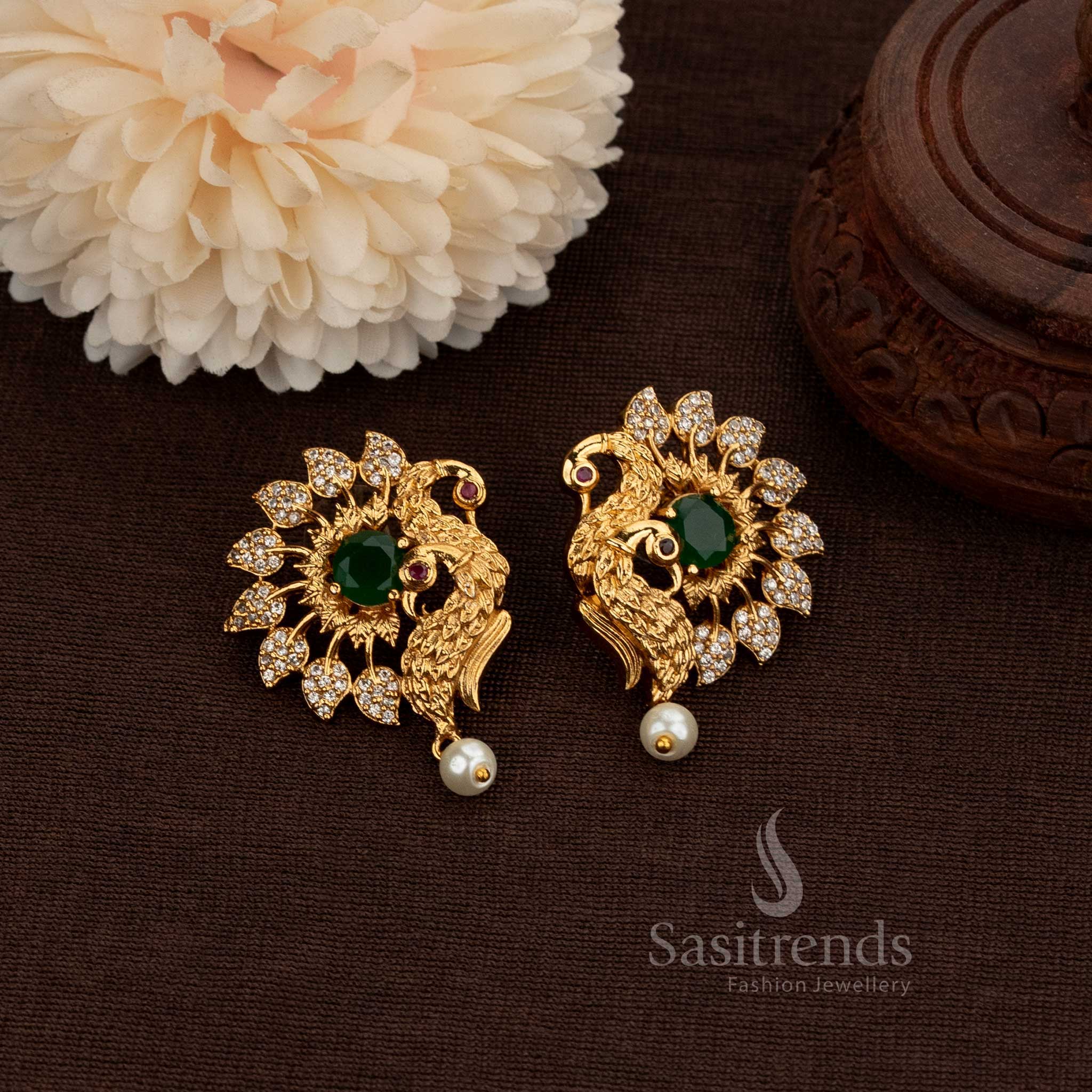 Matte Gold Plated Temple Peacock Stud Earrings Adorned With Sparkling American Diamond Stones And A Graceful Pearl Drop, Perfect For Bridal Ensembles And Festive Occasions – Sasitrends