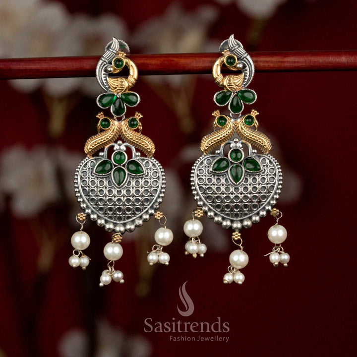 Antique dual tone oxidised silver earrings featuring green Monalisa stones, curved peacock heart design and cascading pearl drops for vibrant ethnic styling - Sasitrends