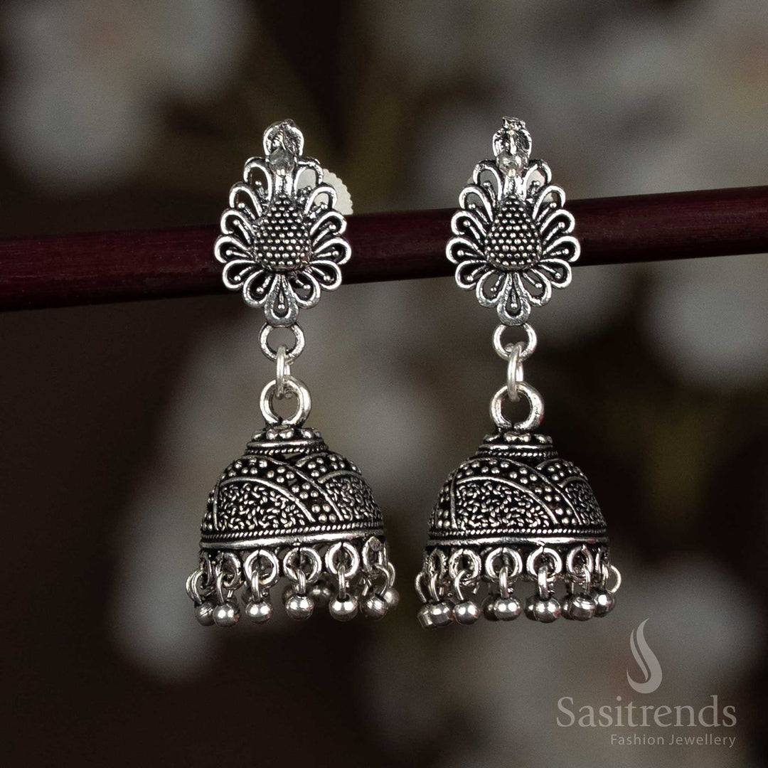 Antique-style oxidised silver jhumka earrings adorned with an intricate peacock motif and engraved dome, adding ethnic charm to sarees and festive wear – Sasitrends