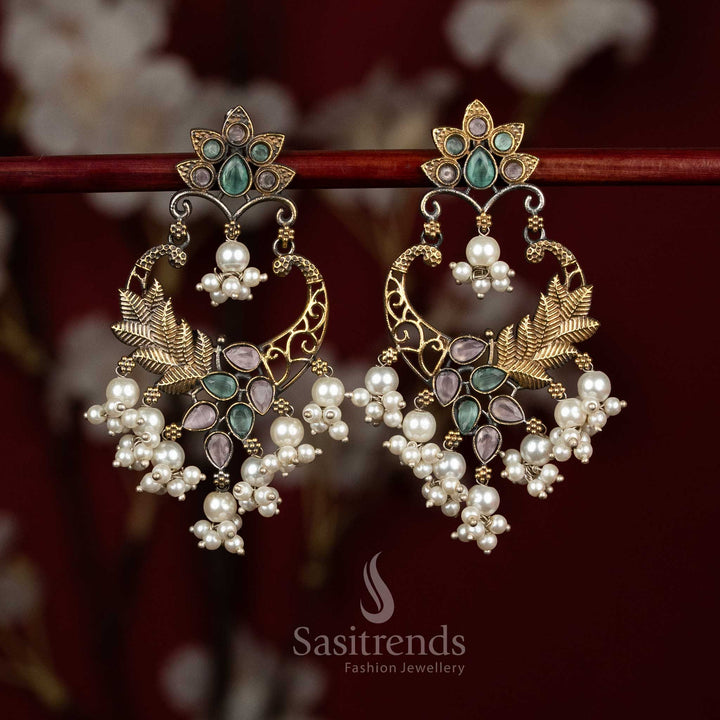 Elegant oxidised silver earrings designed with pink mint Monalisa stones, sculpted mandala chandbali form, peacock arch detailing and pearl bunch hangings for refined ethnic wear - Sasitrends