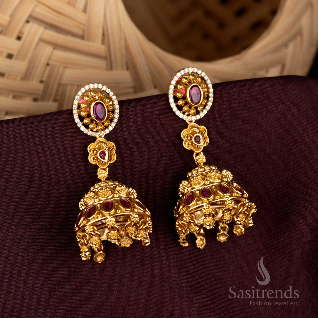 Illustrious white ruby oval-in-circle temple jhumka earrings featuring radiant floral domes, baroque danglers, grandiose matte gold detailing, and sacred bridal artistry – Sasitrends