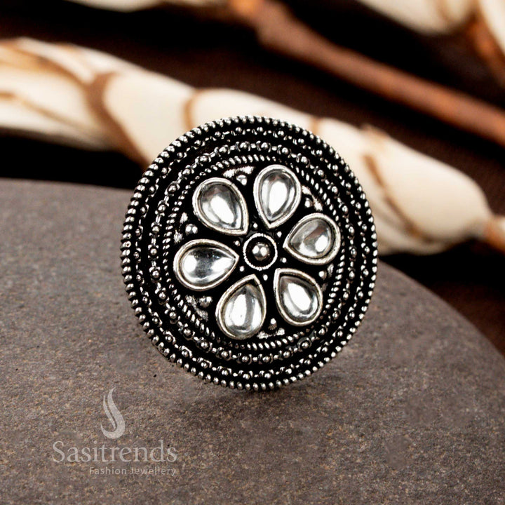 An elegant handmade oxidised adjustable ring with delicate floral patterns and a dazzling white stone, enhancing its charm and grace - Sasitrends