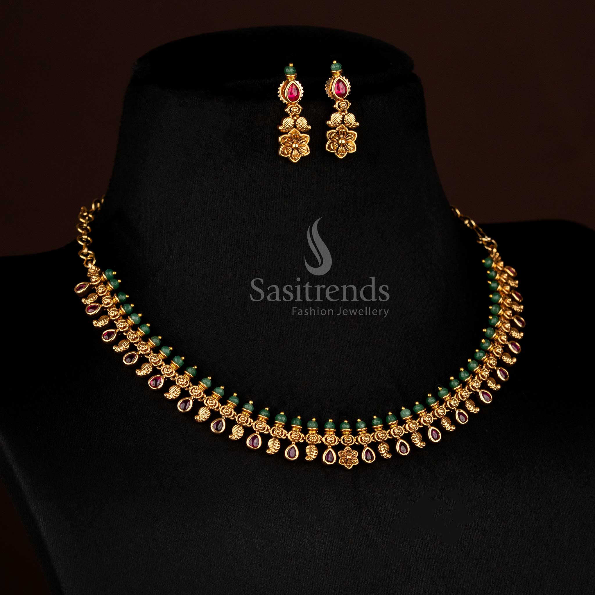 Grace bloom inspired matte gold plated necklace featuring detailed paisley carvings and ruby teardrop stones, designed for graceful temple festive wear – Sasitrends.