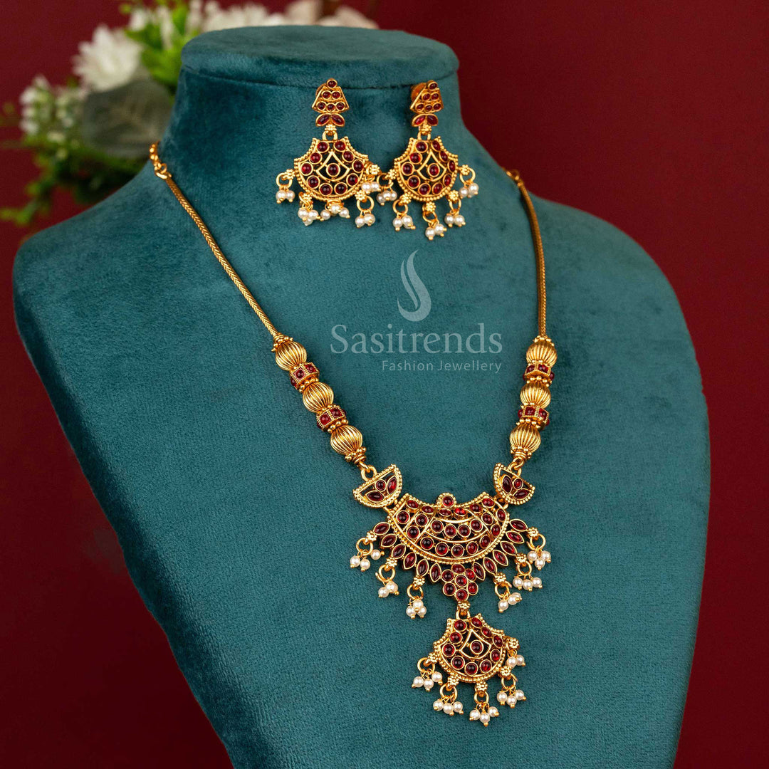 Handcrafted matte gold temple-style necklace with a glowing ruby-toned pendant and devotional carvings reflecting southern craftsmanship and temple heritage – Sasitrends