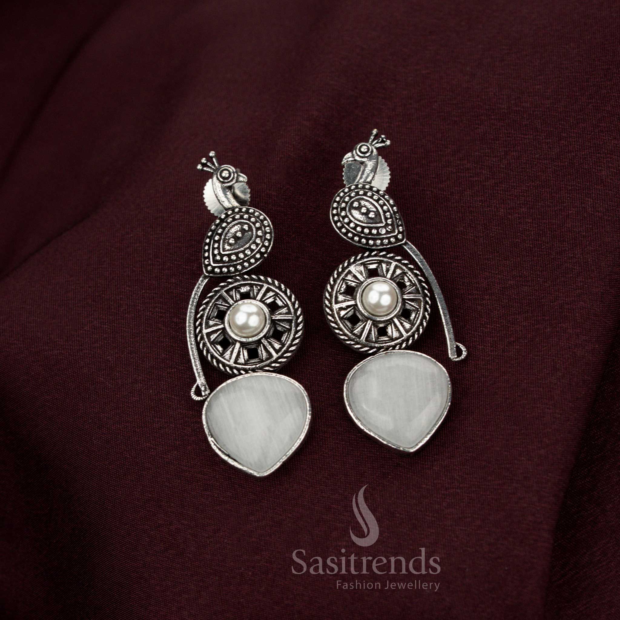Illustrious white oxidised peacock earrings adorned with graceful pearl drops designed for celestial heritage occasions noble elegance and resplendent jewellery style – Sasitrends