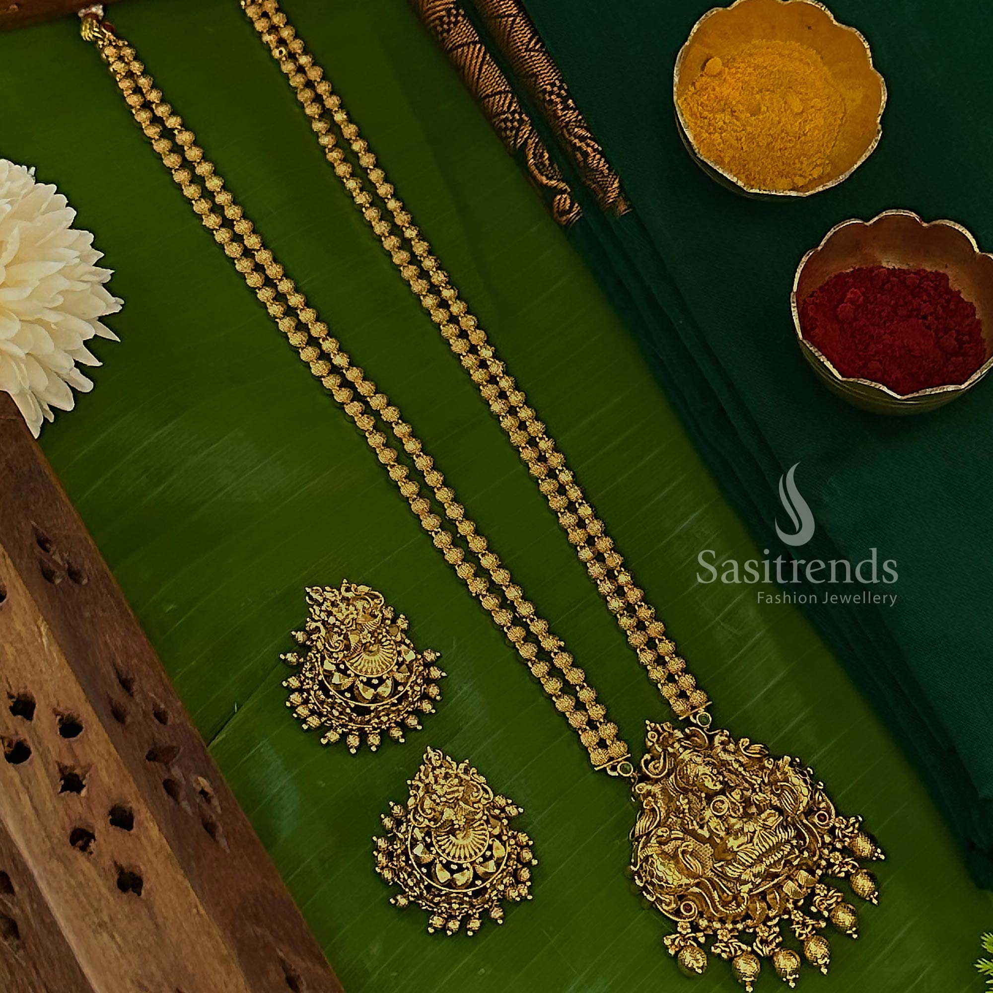 New temple matte gold plated long jewellery set for women featuring a two-layered bead Lakshmi peacock pendant and traditional earrings adorned with lustrous ruby-green stones for festive grandeur – Sasitrends
