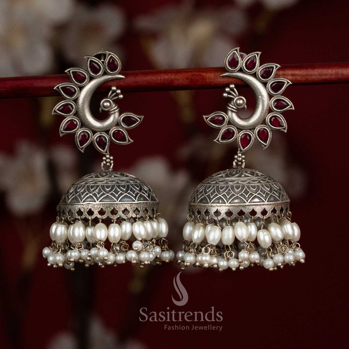 Radiance oxidised 92.5 silver ruby peacock motif dome jhumkas with layered pearls for party - jewellery - Sasitrends