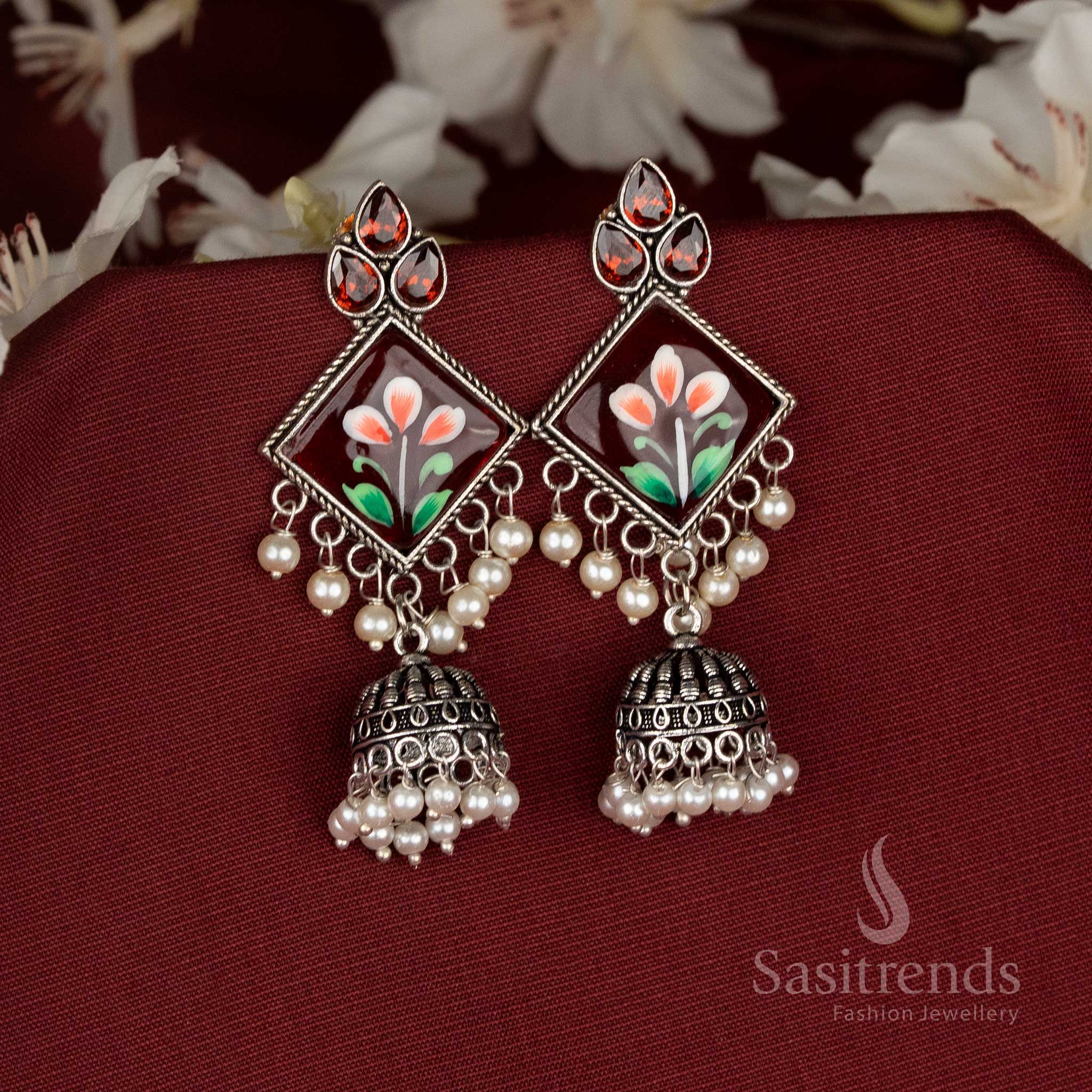 Oxidised jhumka earrings featuring red Monalisa stones and diamond-cut charm for vibrant festive style – Sasitrends