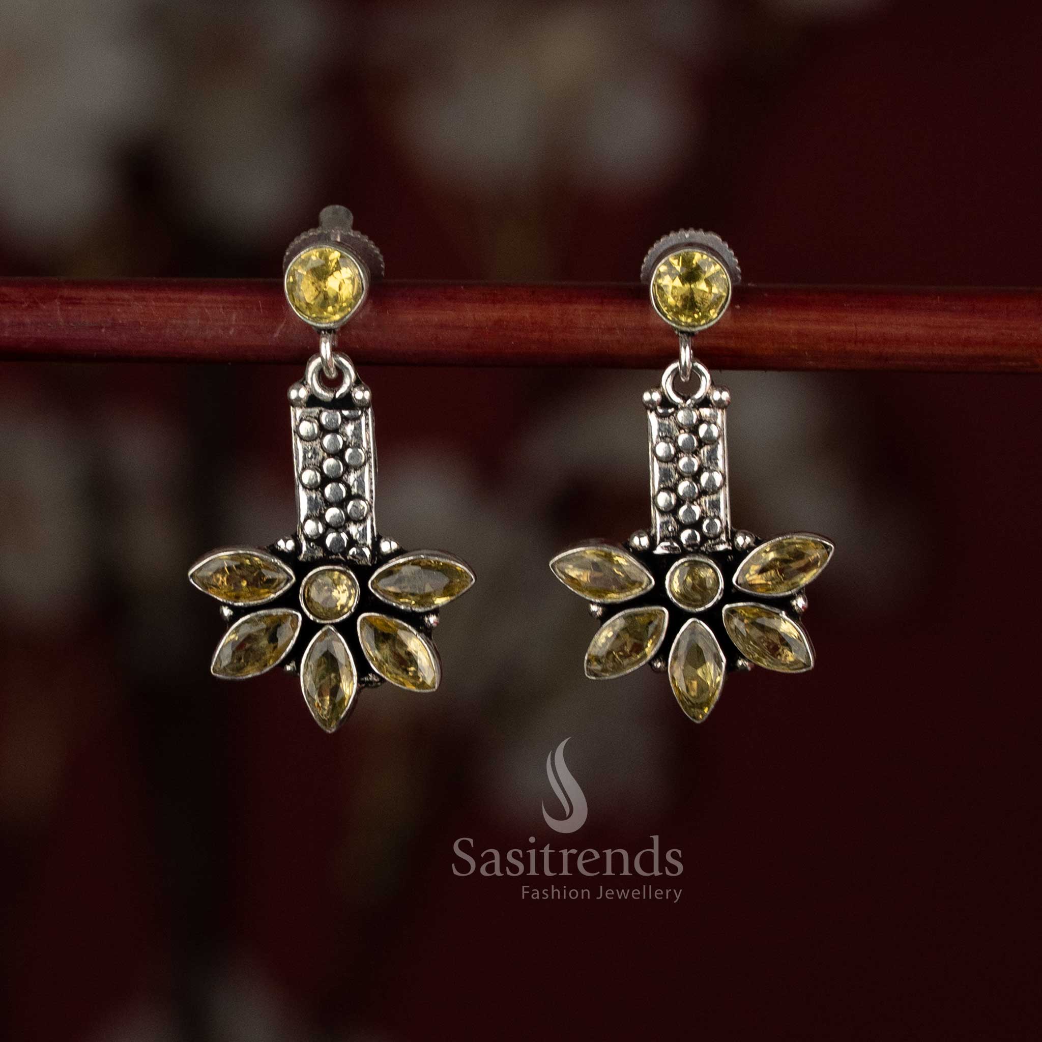 Warm yellow shade oxidised silver earrings with round cap element and leaf-detailed elongated charm – Sasitrends