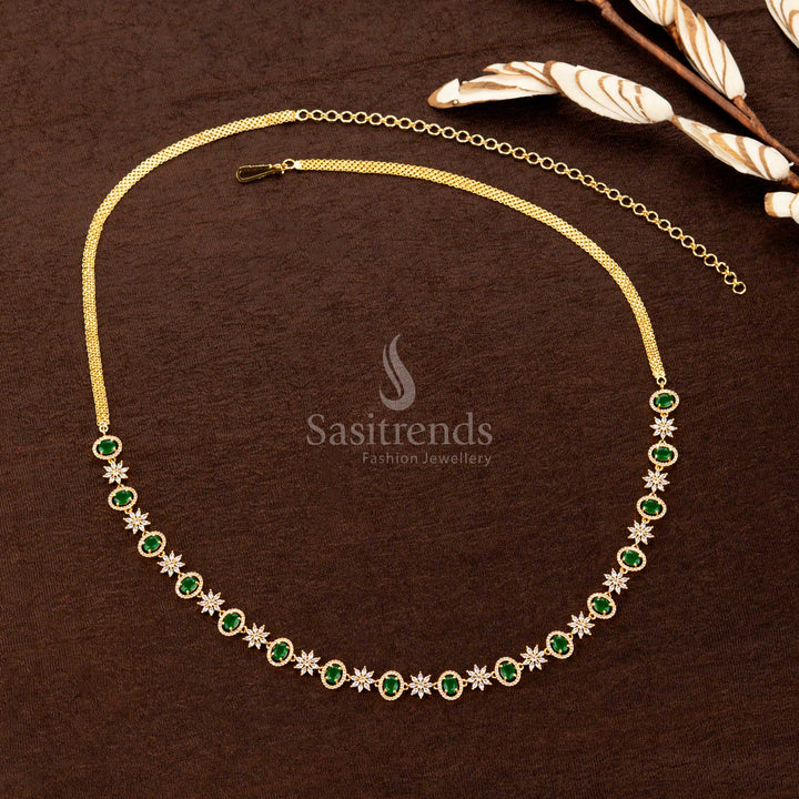 Emerald green gold-plated hip chain featuring sparkling American diamonds, a striking oval gemstone, and intricate floral detailing—an elegant choice for bridal wear - Sasitrends