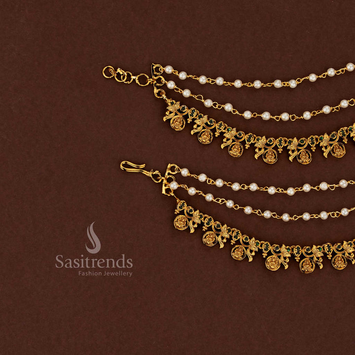 Graceful Lakshmi temple matte gold plated American diamond matils embellished with rich green stones and flowing pearl fringe ideal for auspicious bridal wear - Sasitrends