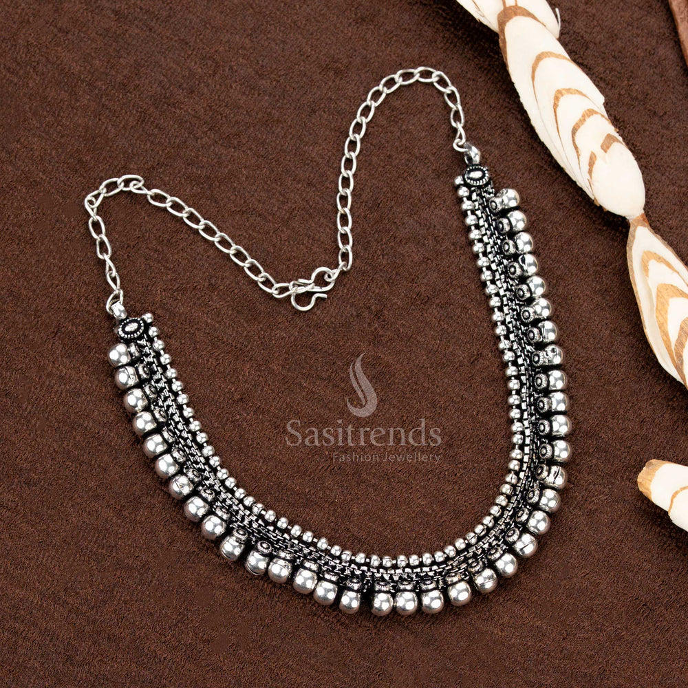 Antique-finish oxidised silver toned necklace set with a classic dual ball row design and intricately carved floral stud earrings, an ideal choice for bridal and Navaratri jewellery - Sasitrends