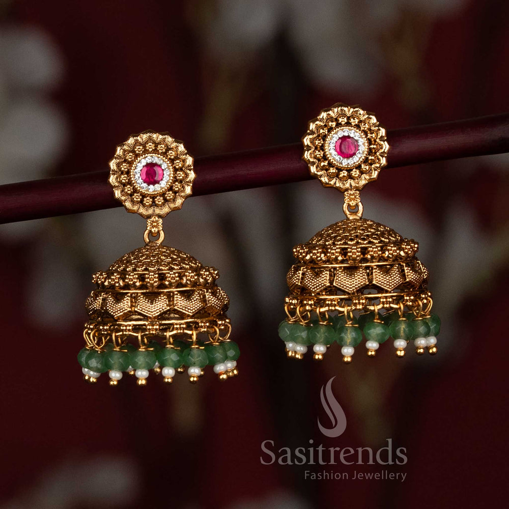 Divine temple-style matte gold plated jhumka earrings embellished with designer AD stones and lustrous decorative bead drops, ideal for weddings and traditional cultural occasions – Sasitrends