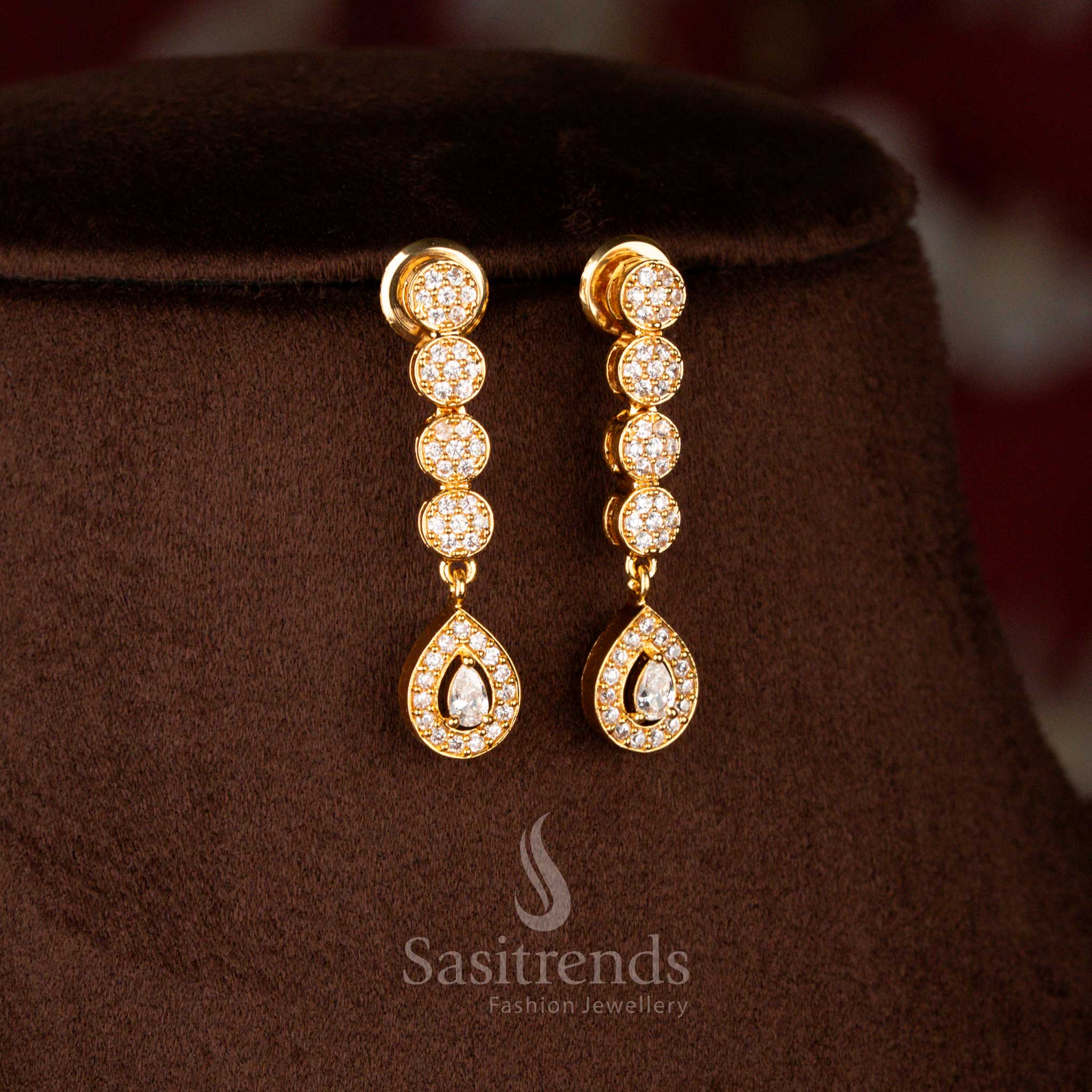 Elegant micro gold plated American Diamond teardrop earrings in white, complementing necklace with luxurious 24K gold finish – Sasitrends