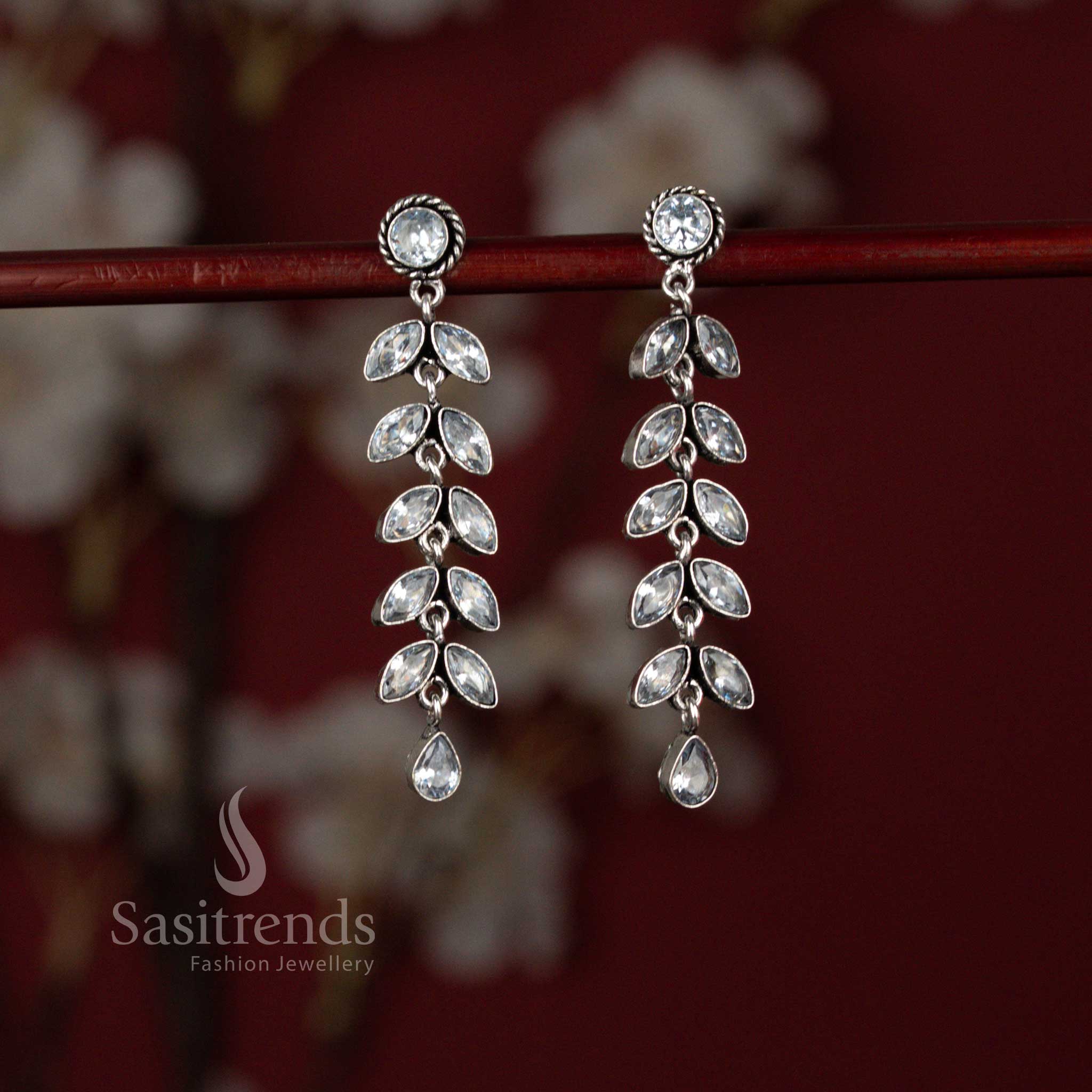 Radiant oxidised leaf line drop earrings highlighted in white elegance ideal for ethnic outfits and celebration styling – Sasitrends