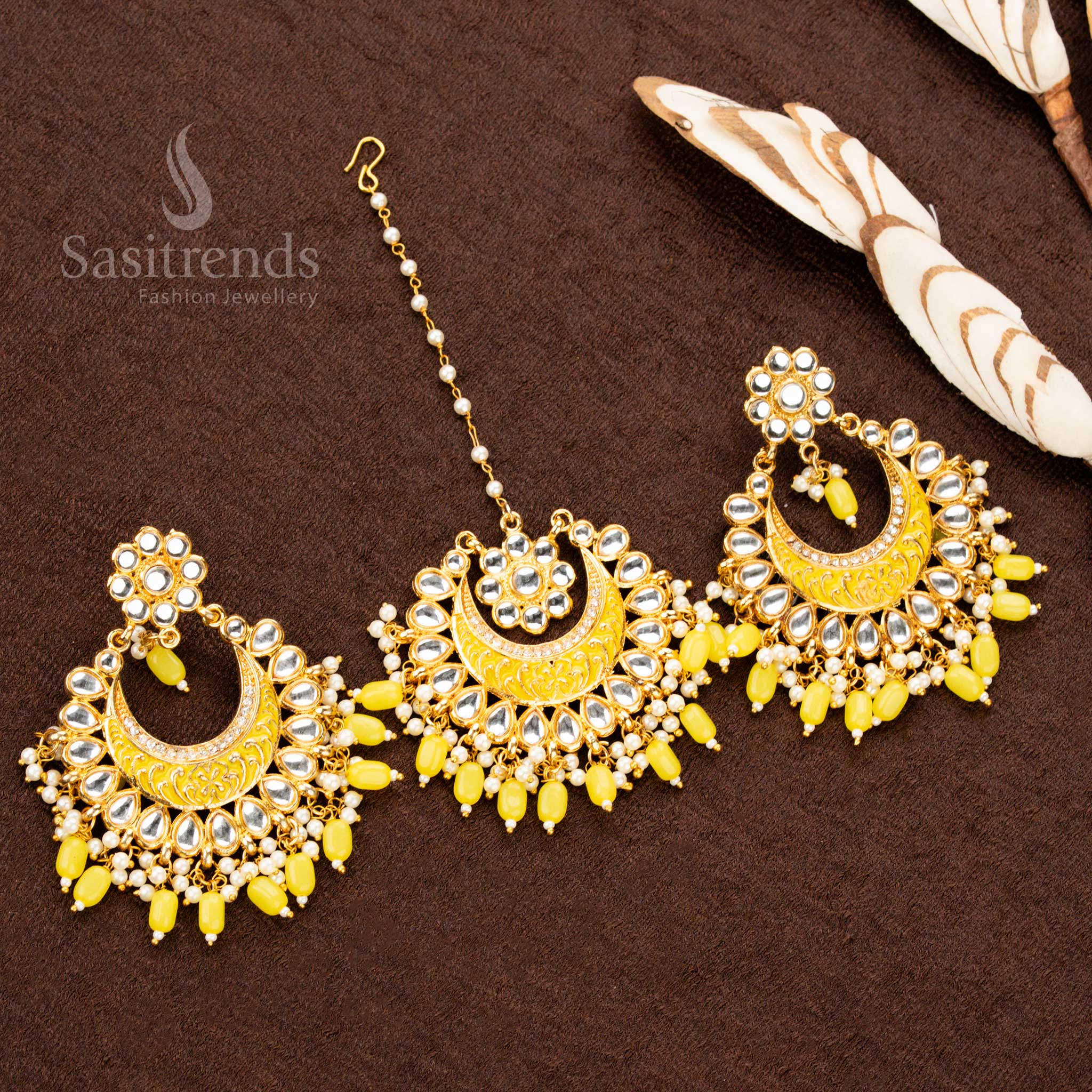 Vibrant gold plated colourful painted tikka and earrings set, adorned with sunshine yellow stone embellishments, intricate artwork, and elegant bead drops - Sasitrends