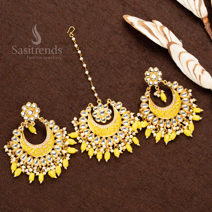 Vibrant gold plated colourful painted tikka and earrings set, adorned with sunshine yellow stone embellishments, intricate artwork, and elegant bead drops - Sasitrends
