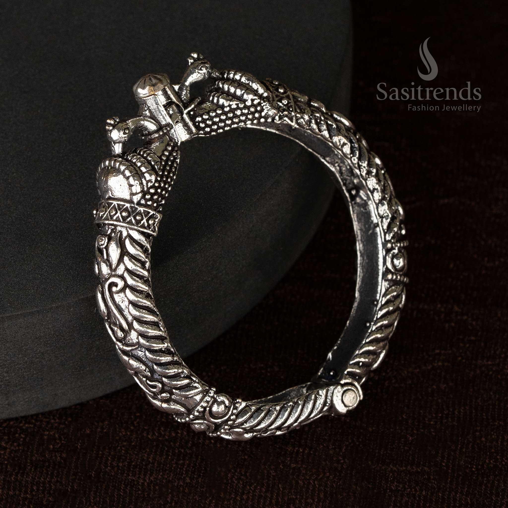 An oxidized screw-type kada bangle with ethnic floral and elephant patterns, ideal for ethnic occasions - Sasitrends