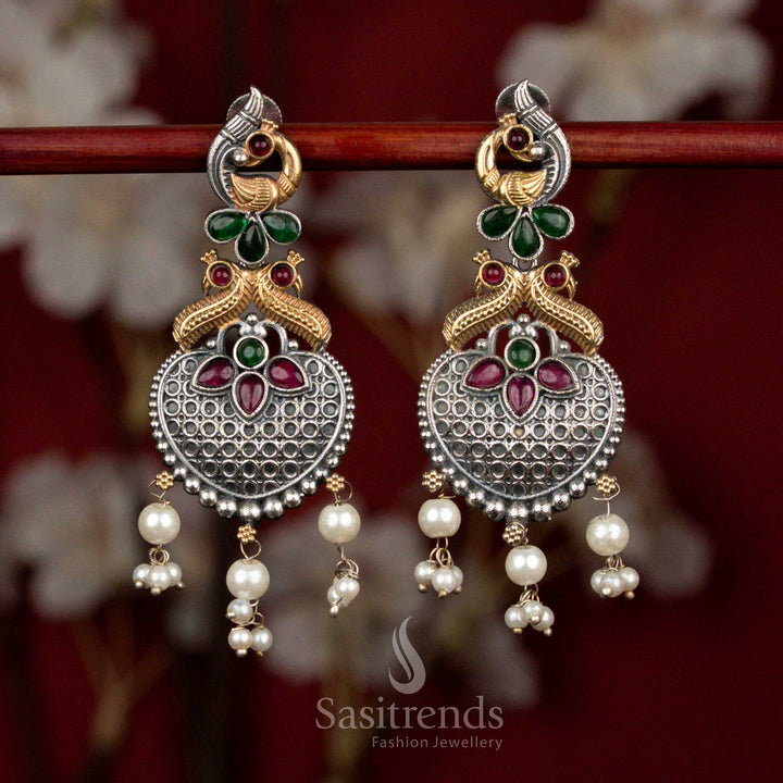 Fusion ruby-green Monalisa stone earrings in oxidised silver, dual tone peacock heart motifs with pearl hangings for colourful festive styling - Sasitrends