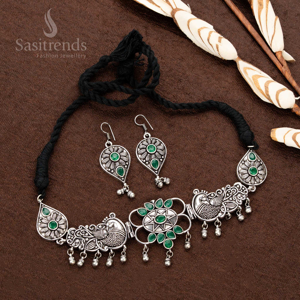 xquisite oxidised silver necklace set, featuring royal green stones, detailed peacock engravings, and an ornate teardrop-studded pendant, a must-have piece for ethnic jewellery enthusiasts - Sasitrends