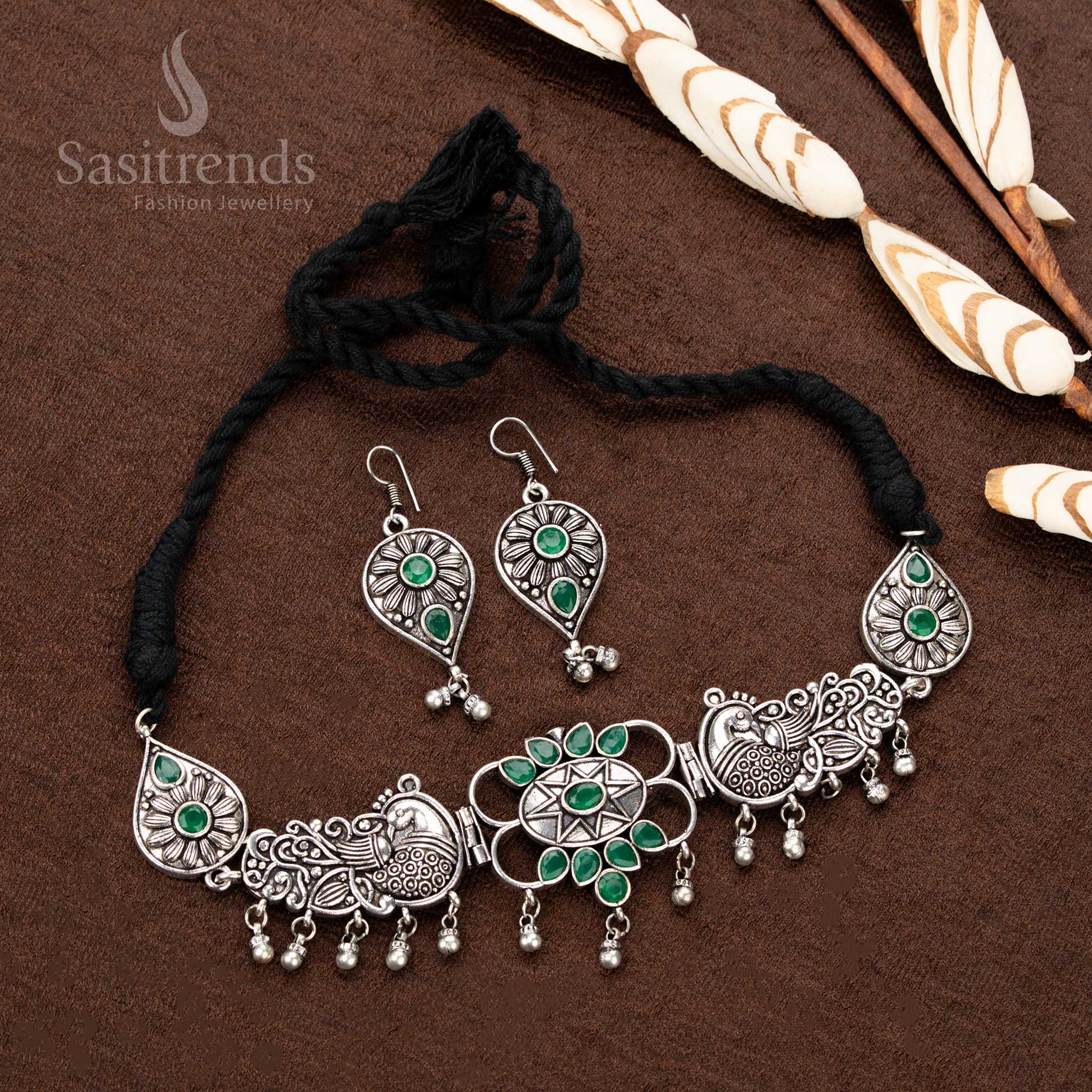 xquisite oxidised silver necklace set, featuring royal green stones, detailed peacock engravings, and an ornate teardrop-studded pendant, a must-have piece for ethnic jewellery enthusiasts - Sasitrends