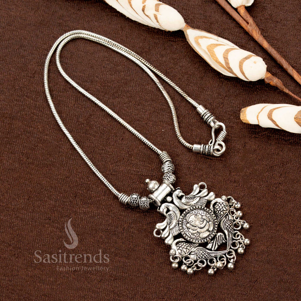 Heritage-inspired oxidised necklace with an artistic Ganesha and peacock pendant, enhanced by antique-style ball embellishments, ideal for temple jewellery lovers and festive traditions - Sasitrends