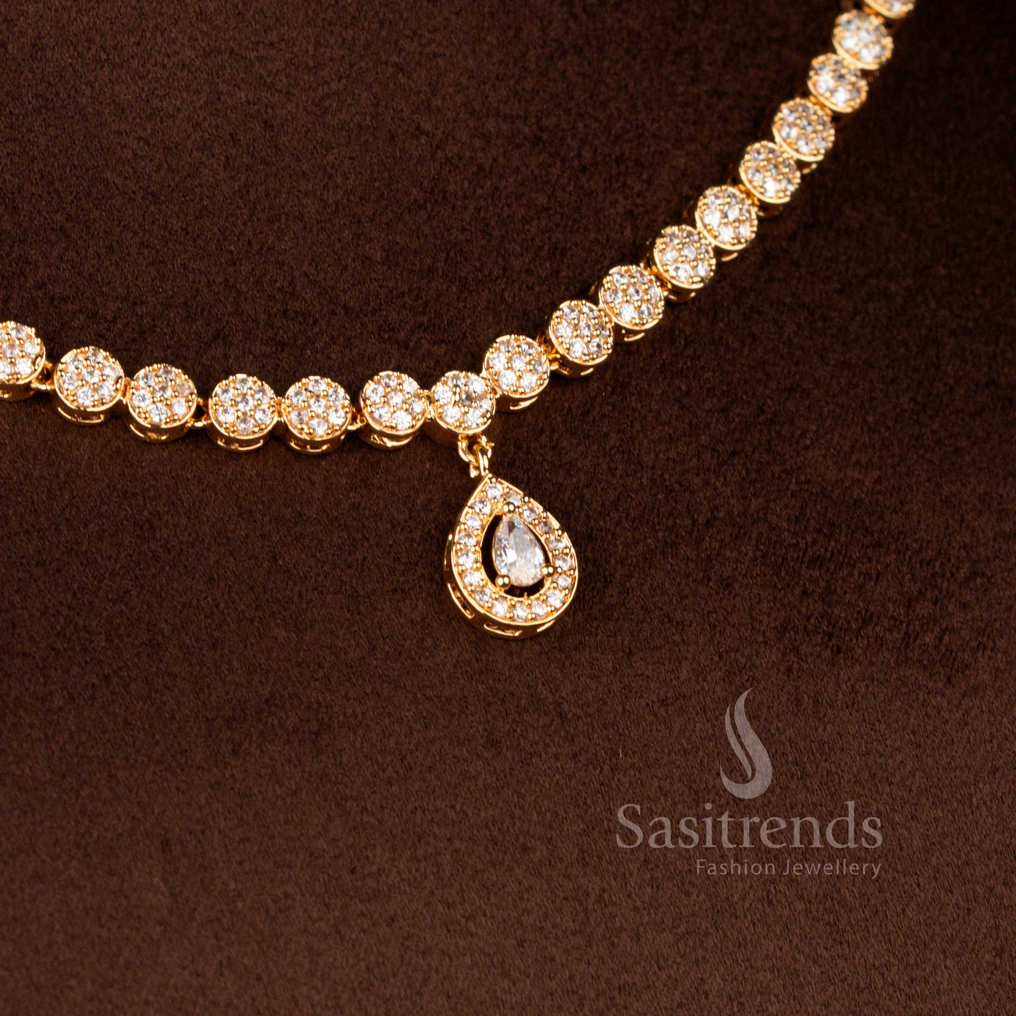 Radiant micro gold plated American Diamond round halo necklace in white shimmer paired with a graceful teardrop pendant and matching earrings finished with 24 carat gold polish – Sasitrends