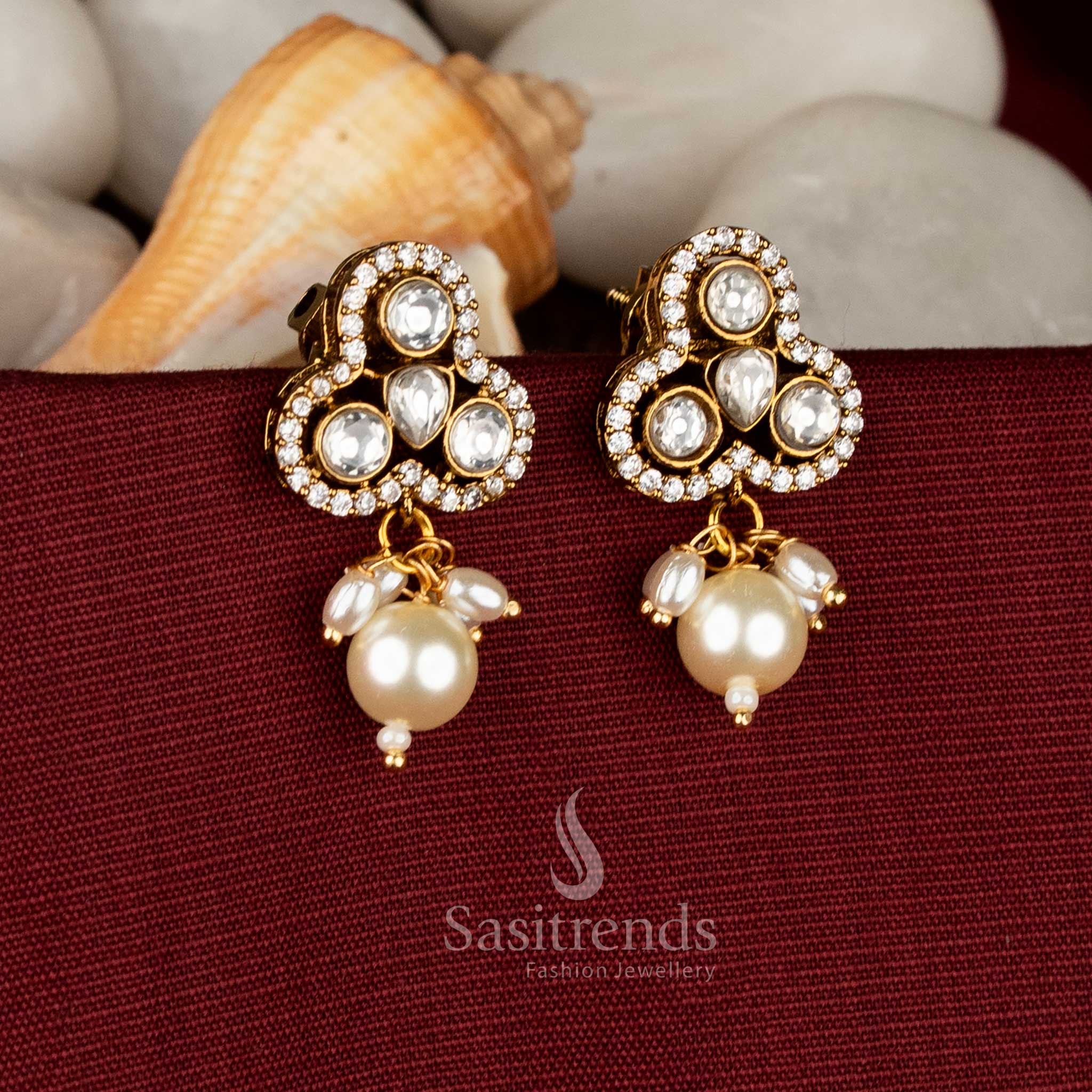 Ivory classic Victorian inspired three-petal stud earrings flaunting white AD sparkle and graceful pearl danglers for reception styling – Sasitrends
