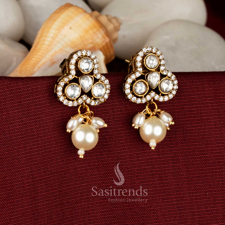 Ivory classic Victorian inspired three-petal stud earrings flaunting white AD sparkle and graceful pearl danglers for reception styling – Sasitrends