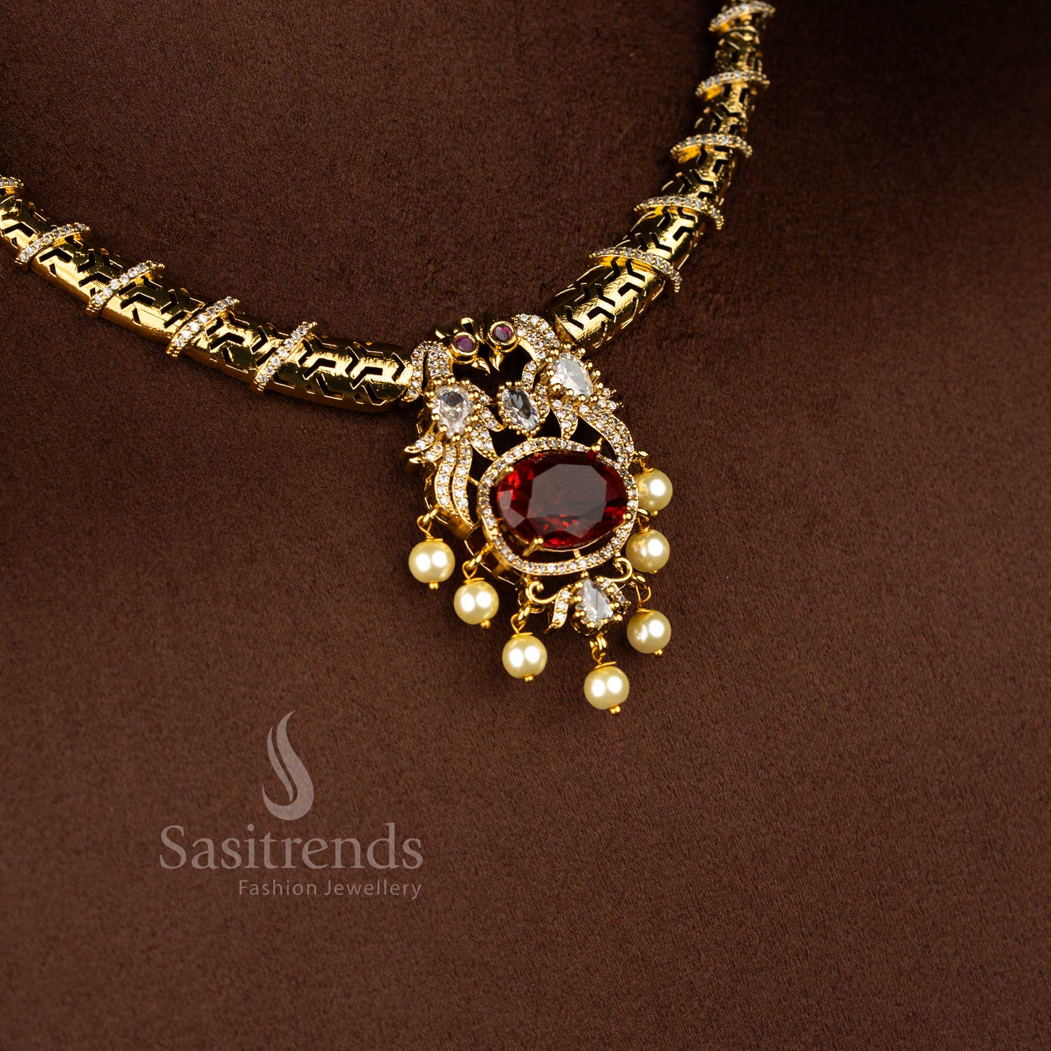 Velvet majesty matte gold plated peacock necklace featuring curved bar cylinder link pattern and elegant white red stone combination – Sasitrends