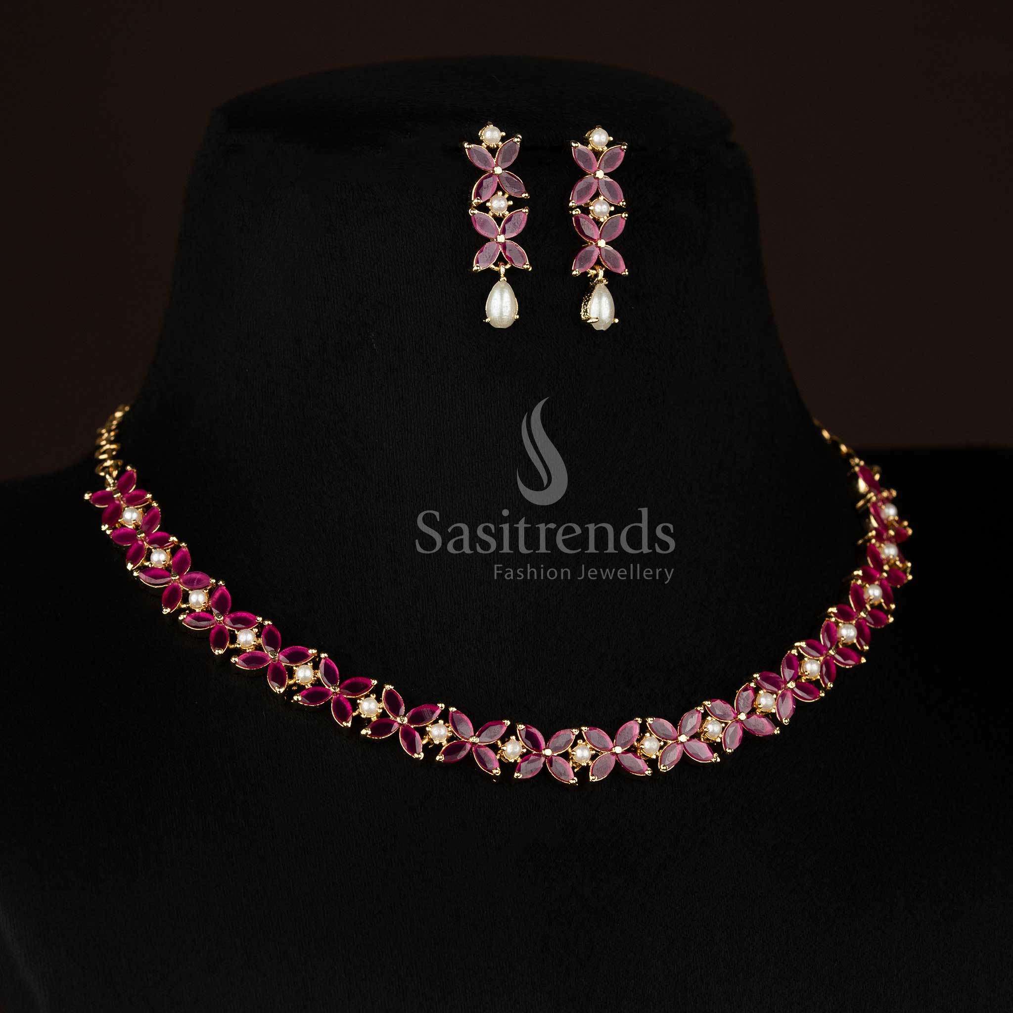 Chic micro gold plated ruby four petal AD floral necklace set with pearls curated for ceremonial styling and festive jewellery -Sasitrends