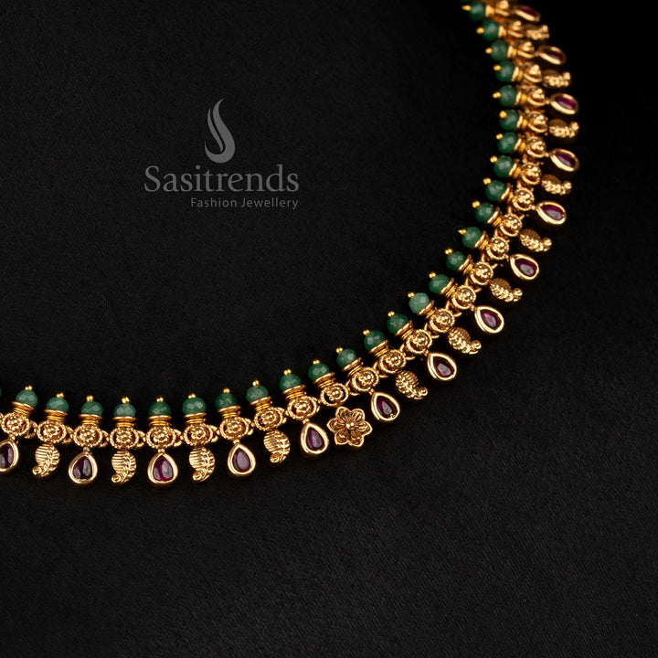 Serene and artful matte gold plated paisley necklace enriched with ruby floral motifs and delicate teardrop stone accent, ideal for festive celebrations – Sasitrends