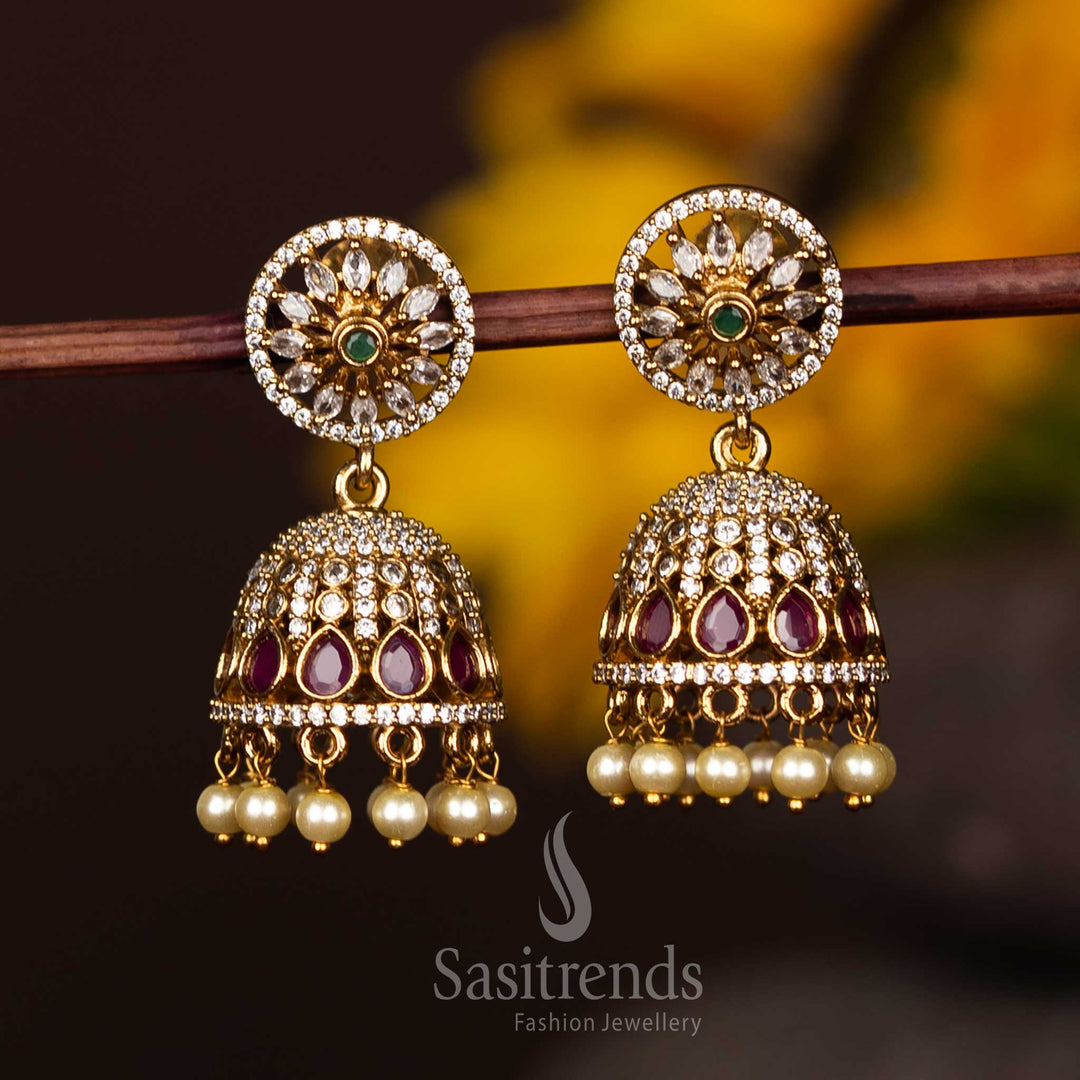 Stunning Matte Gold Floral Jhumka Earrings Designed With Kemp AD Stones And Elegant Pearl Details – Jewellery To Elevate Festive And Ethnic Outfits – Sasitrends
