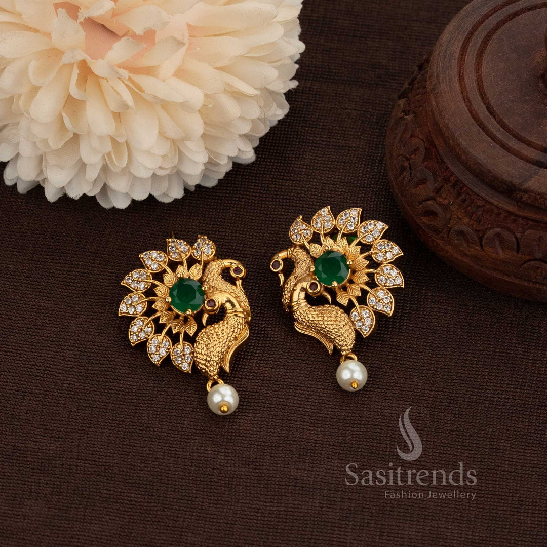 Matte Gold Plated Temple Peacock Stud Earrings Featuring Sparkling American Diamond Stones And An Exquisite Pearl Drop, Designed For Royal Bridal Fashion And Festive Grandeur – Sasitrends
