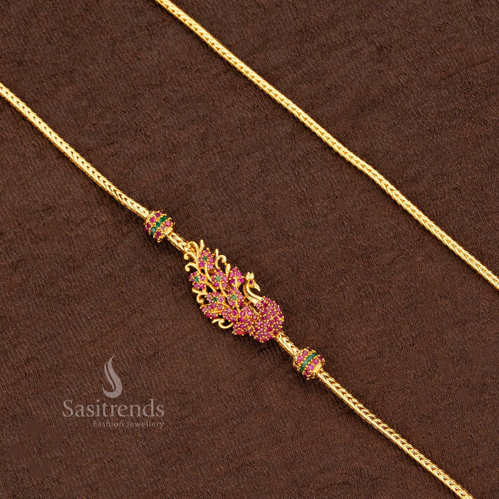 Grand ruby-green Peacock Mugappu Chain with one gram gold plating, detailed with American Diamond accents and temple-inspired floral elements – a radiant jewellery piece exuding heritage charm and festive elegance – Sasitrends