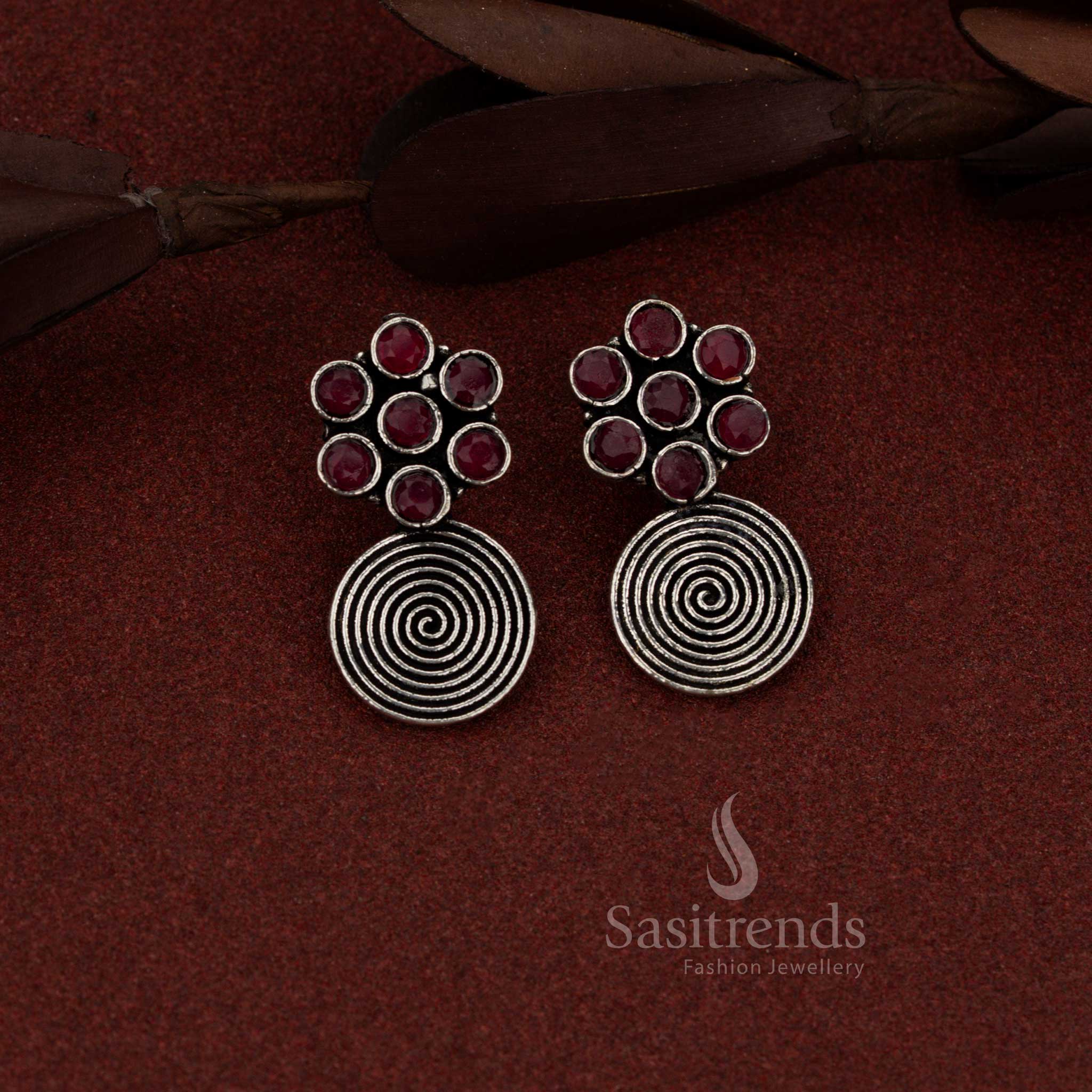 Regal oxidised silver floral spiral dangler earrings in ruby colour suited for festive outings and special evenings – Sasitrends