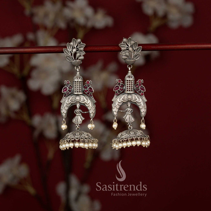 Regal temple style oxidised jhumka earrings adorned with ruby highlights, carved dancer figure and pearl hangings perfect for ceremonies and cultural gatherings – Sasitrends