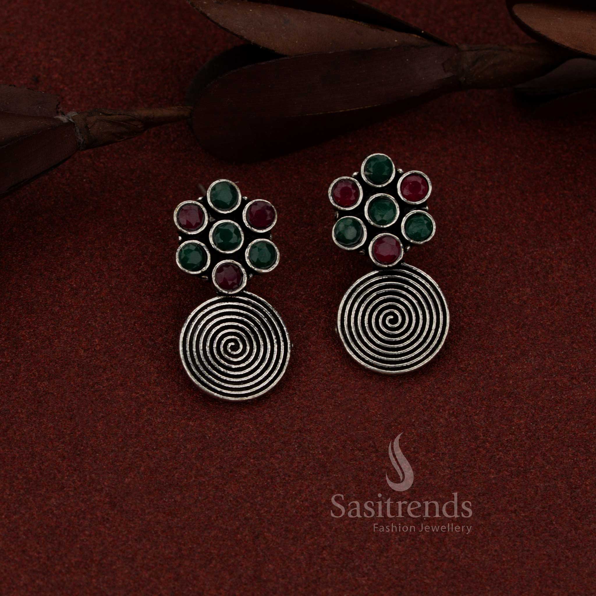 Opulent oxidised spiral flower drop earrings with ruby green stones suited for traditional gatherings and events – Sasitrends