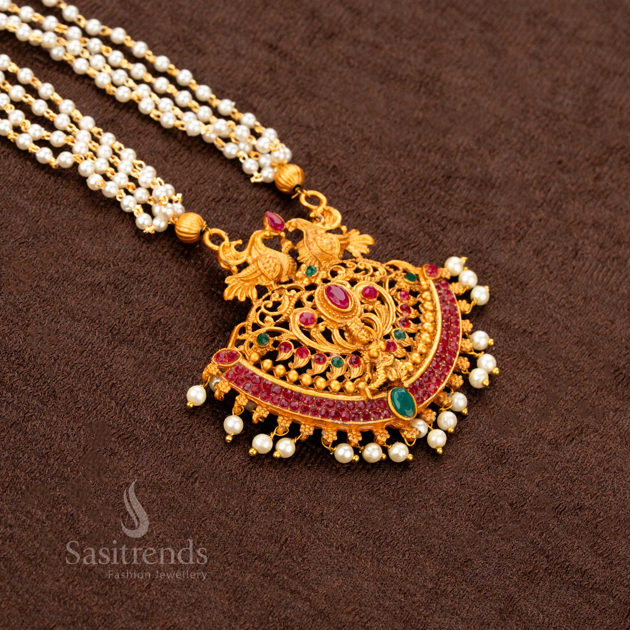 Classic temple matte gold plated Lakshmi and peacock motif necklace set with ruby-green stones, antique temple pendant, and pearl hangings—a regal heritage jewellery design ideal for traditional sarees and wedding occasions - Sasitrends