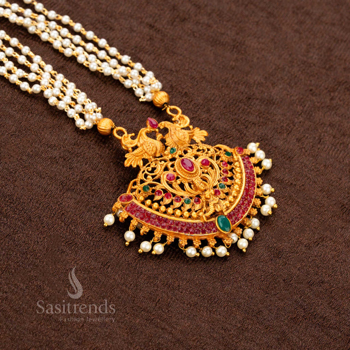 Classic temple matte gold plated Lakshmi and peacock motif necklace set with ruby-green stones, antique temple pendant, and pearl hangings—a regal heritage jewellery design ideal for traditional sarees and wedding occasions - Sasitrends