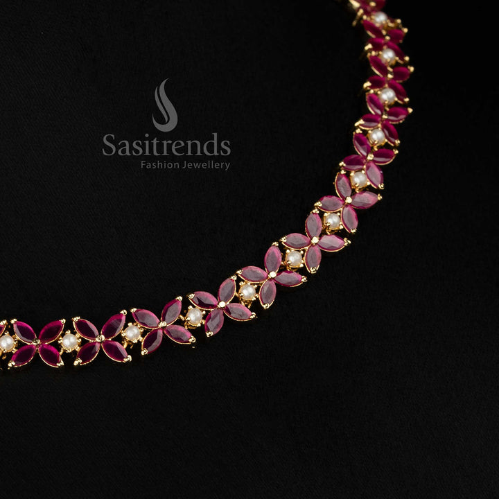 Regal micro gold plated ruby four petal AD floral Necklace with pearls crafted for party styling and festive celebrations -Sasitrends