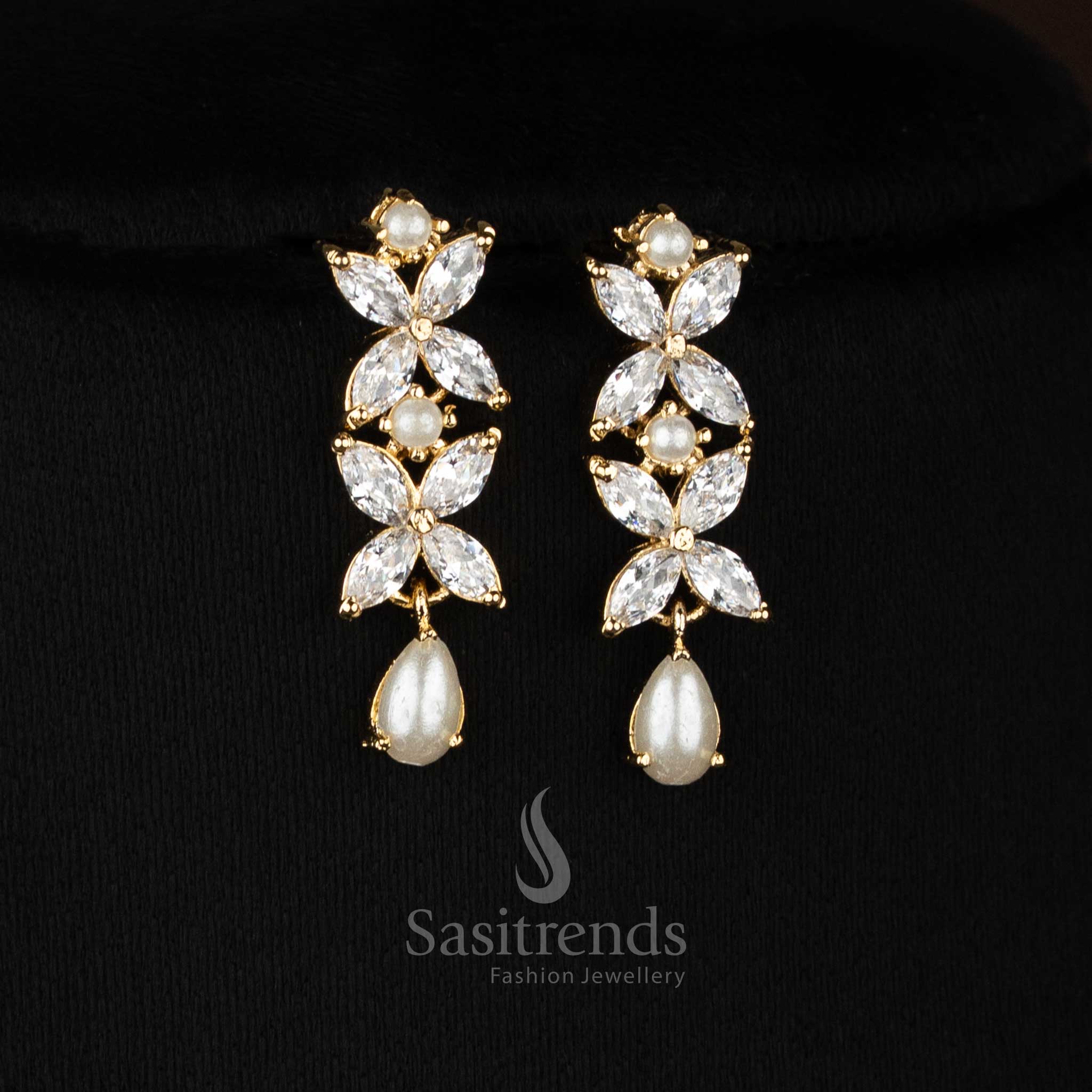 Majestic micro gold plated white four petal AD floral earrings with pearls designed for elegant party styling and festive wear -Sasitrends