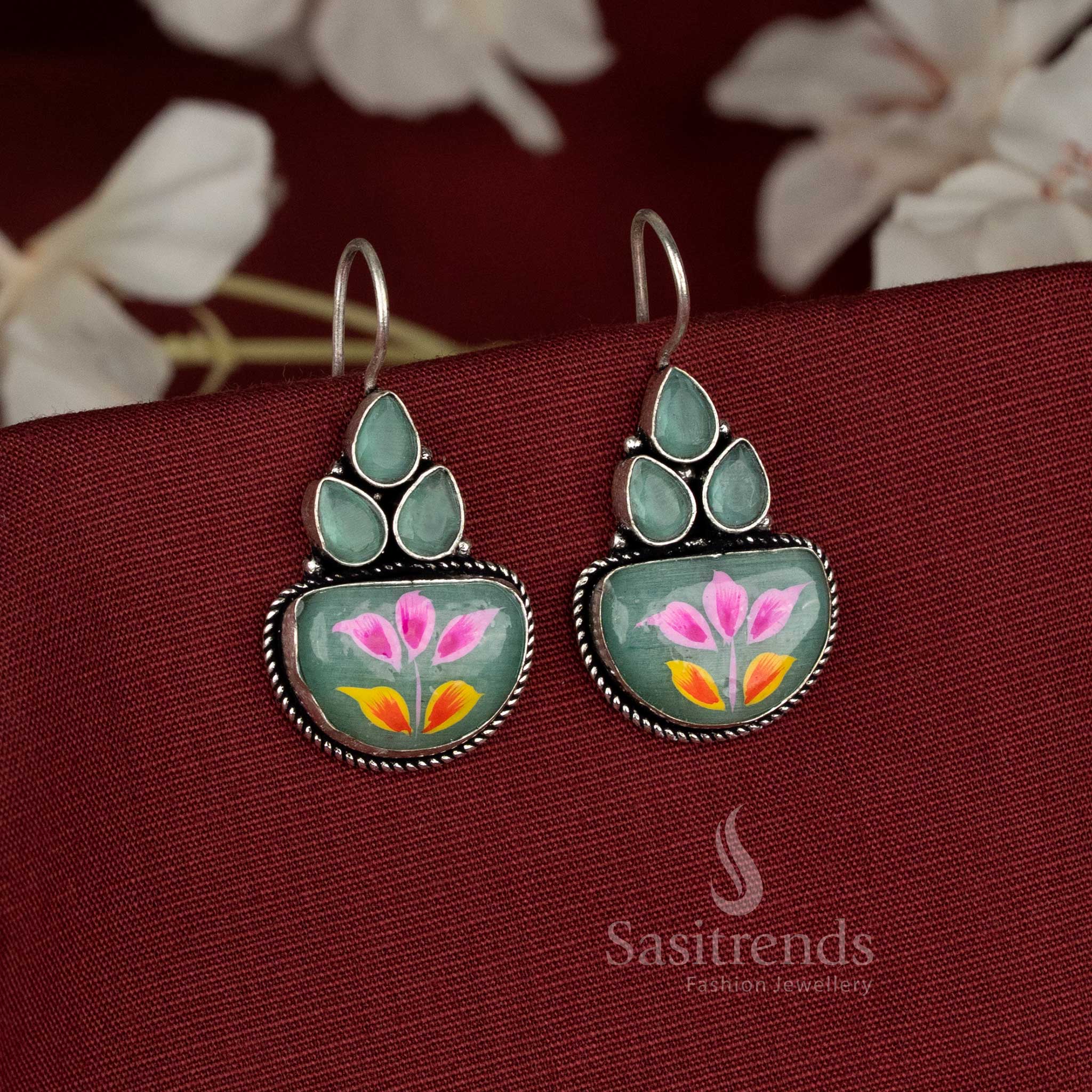 Softmint oxidised floral cluster earrings highlighted using Monalisa stones and graceful fish hook styling – Sasitrends