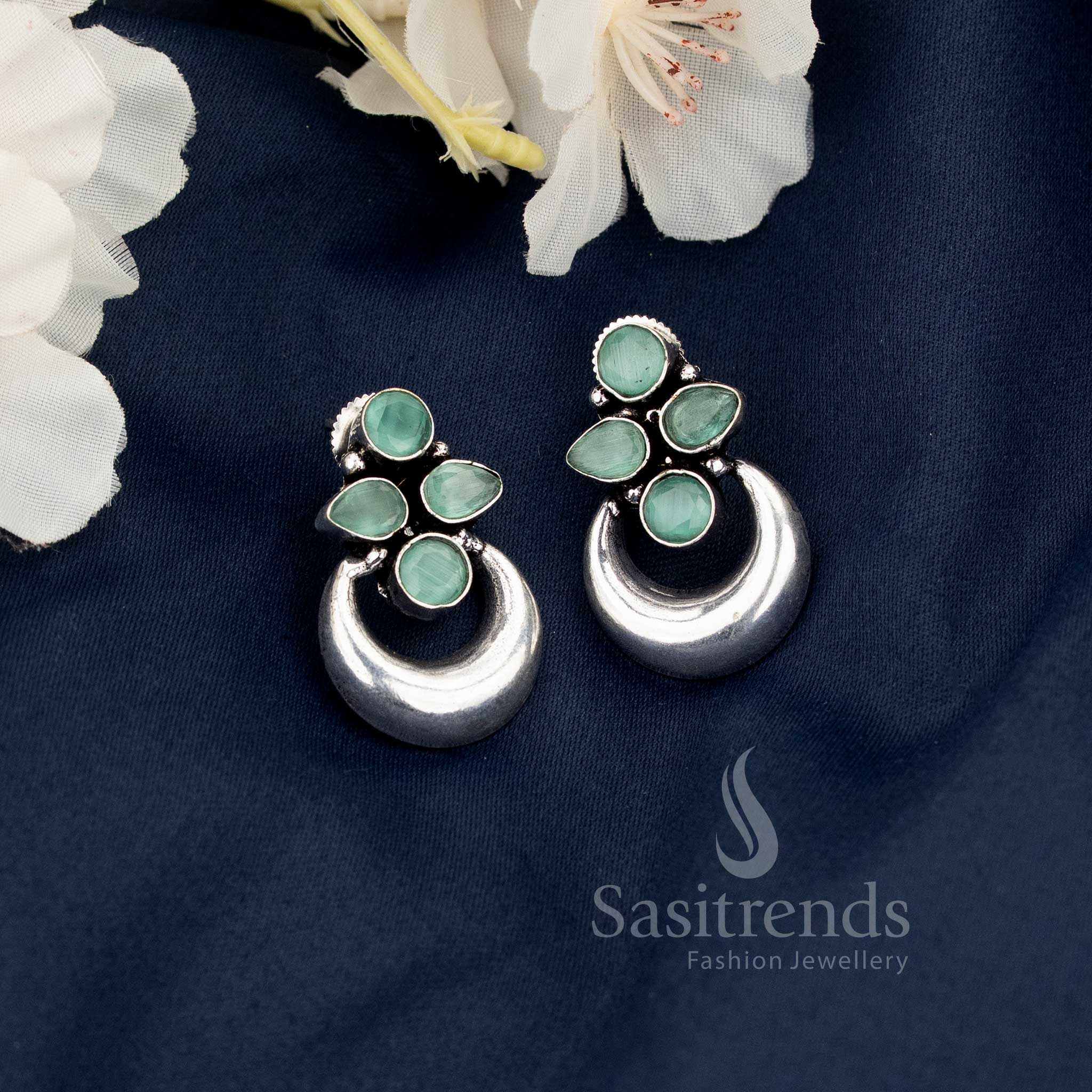 Chic mint oxidised floral half moon earrings blending contemporary elegance with ethnic artistry, ideal for Navaratri ethnic fusion outfits by Sasitrends