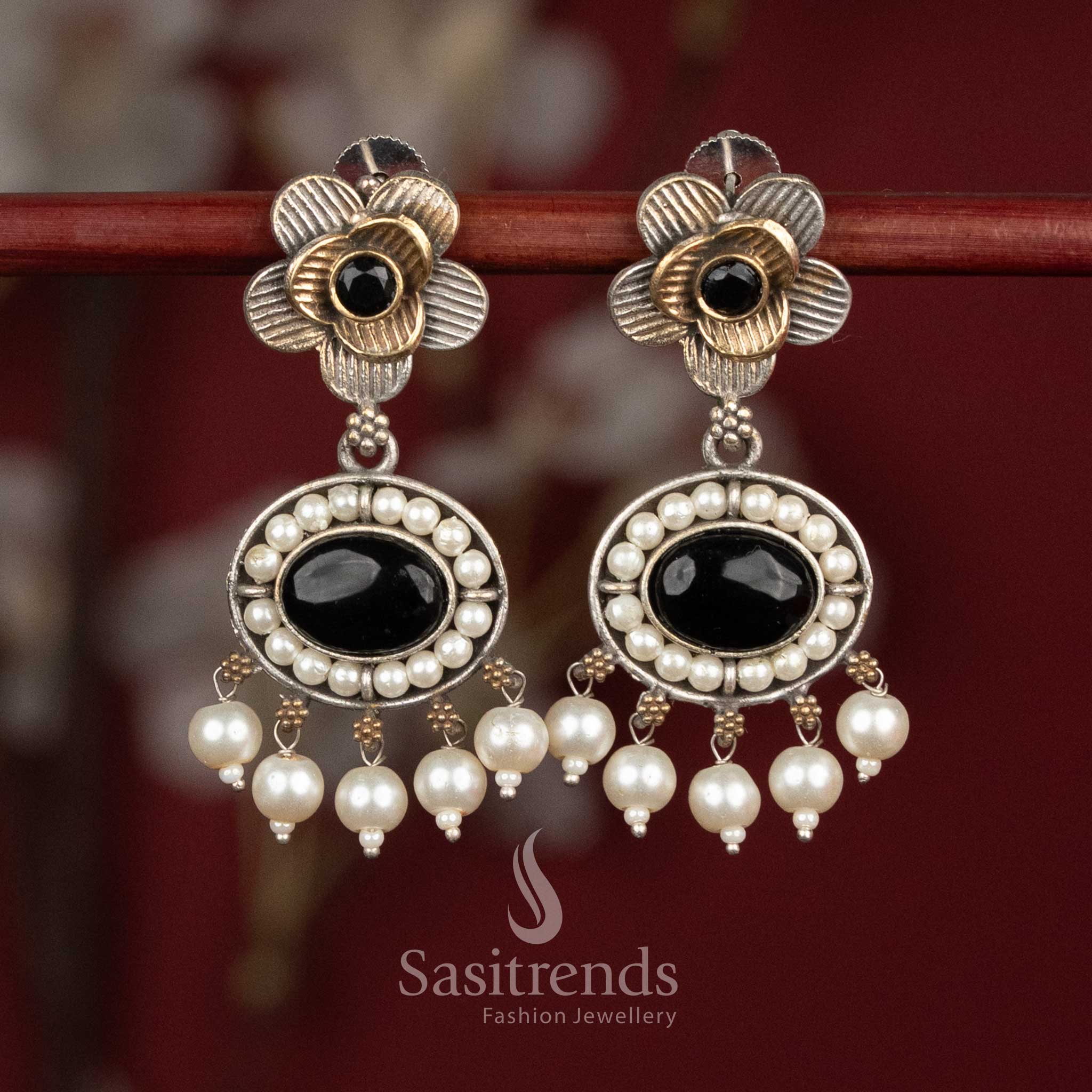 Antique oxidised silver floral studs featuring black Monalisa stones, sculpted floral motifs and pearl cluster hangings for statement festive wear - Sasitrends