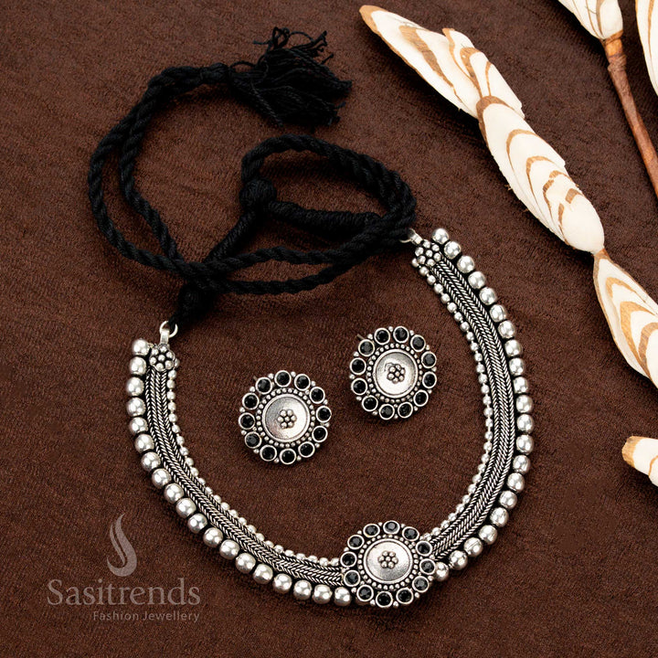 Traditional Kolapuri oxidised choker jewellery with midnight onyx black stones in a dual-tone floral design, adding drama and grace to sarees and festive Indian outfits - Sasitrends