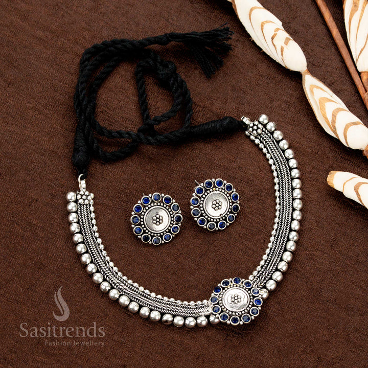 Kolapuri choker set in oxidised silver with royal peacock blue stone accents, detailed floral design, and a majestic antique dual-tone style — ideal for sarees, Garba nights, and cultural festivities - Sasitrends